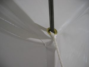 Haiti disaster relief tent, detail showing brass grommets heavy duty tie downs and stakes to withstand strong winds.